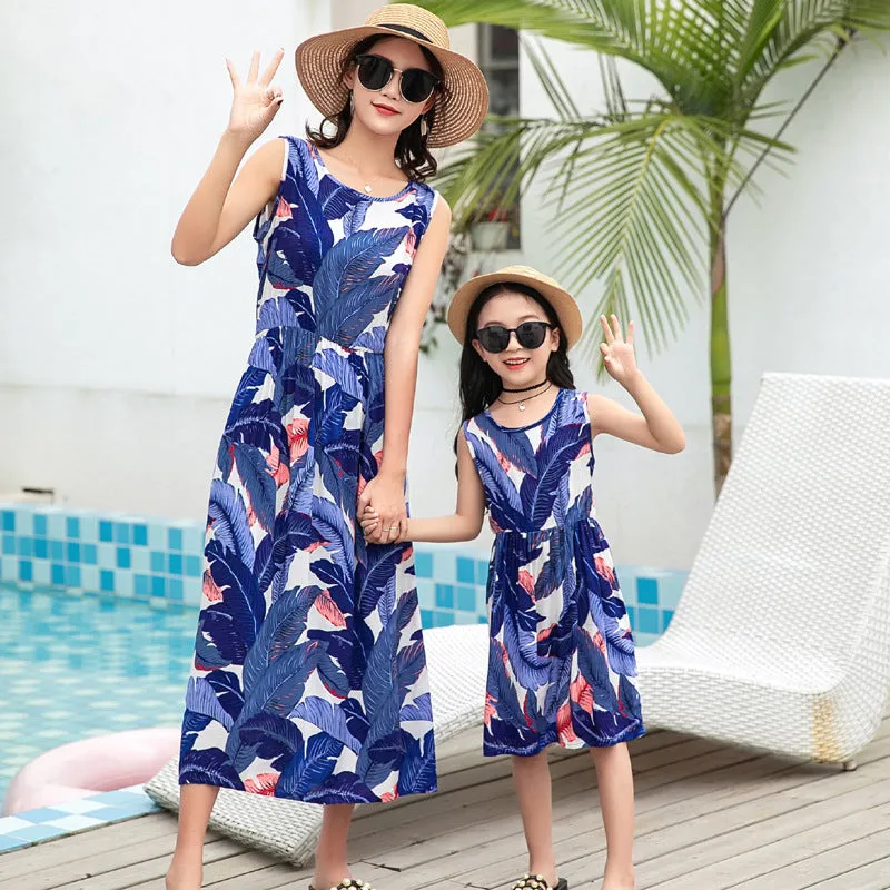 Mother and daughter wearing matching JWH vest and long skirt set in banana leaf print for beach vacation