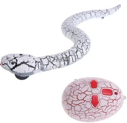Novelty Remote Control Snake in green colour, 38 cm plastic toy with retractable tongue on a wooden floor