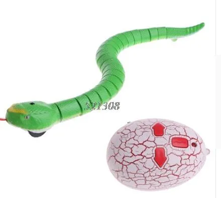 Novelty Remote Control Snake in green colour, 38 cm plastic toy with retractable tongue on a wooden floor