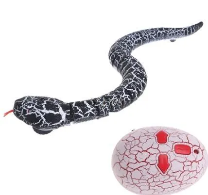 Novelty Remote Control Snake in green colour, 38 cm plastic toy with retractable tongue on a wooden floor