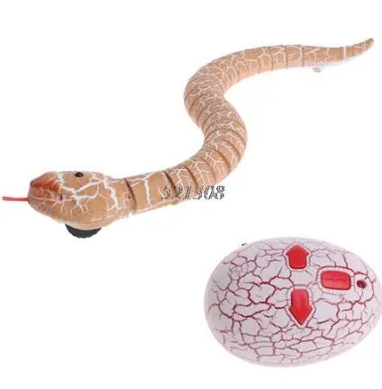 Novelty Remote Control Snake in green colour, 38 cm plastic toy with retractable tongue on a wooden floor