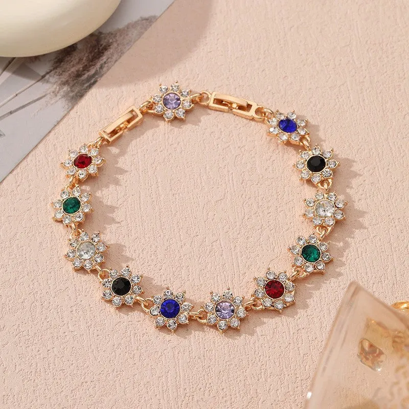 Electroplated zinc alloy flower bracelet with coloured crystals in gold or silver finish.