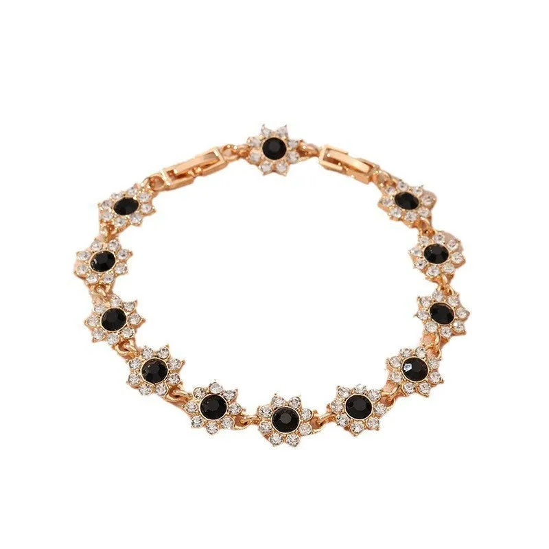 Electroplated zinc alloy flower bracelet with coloured crystals in gold or silver finish.