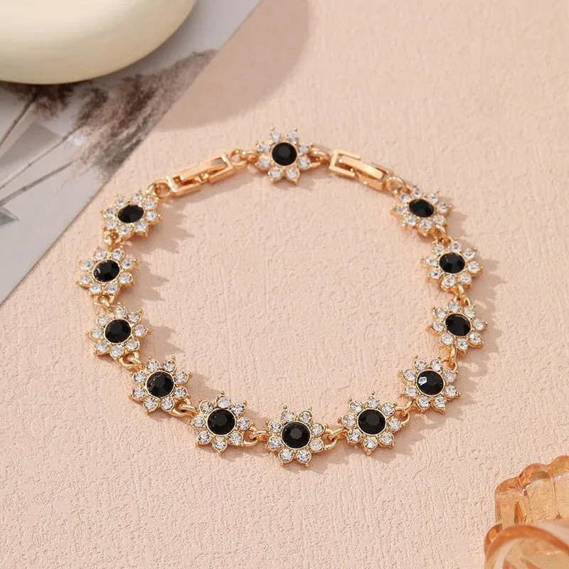 Electroplated zinc alloy flower bracelet with coloured crystals in gold or silver finish.