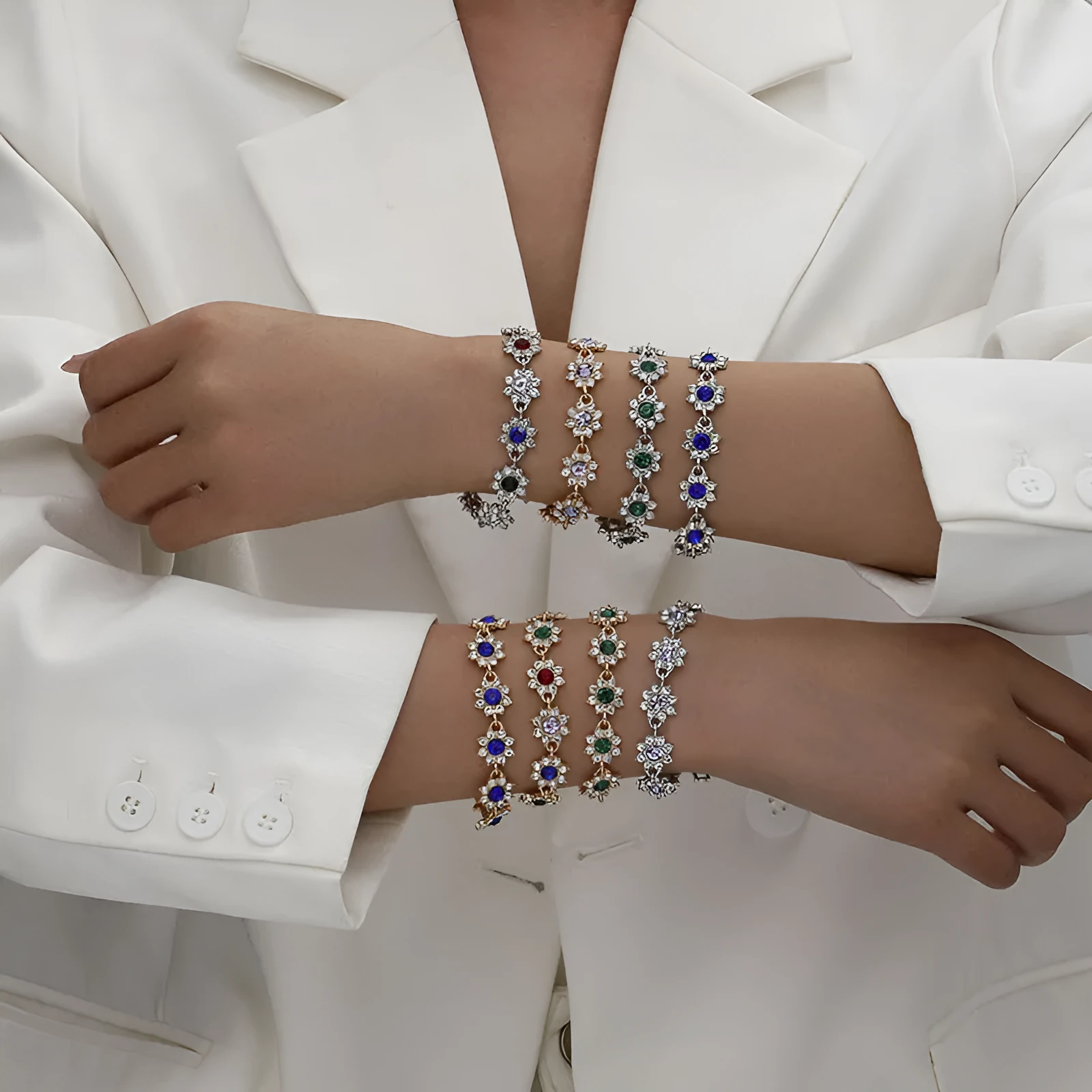 Electroplated zinc alloy flower bracelet with coloured crystals in gold or silver finish.