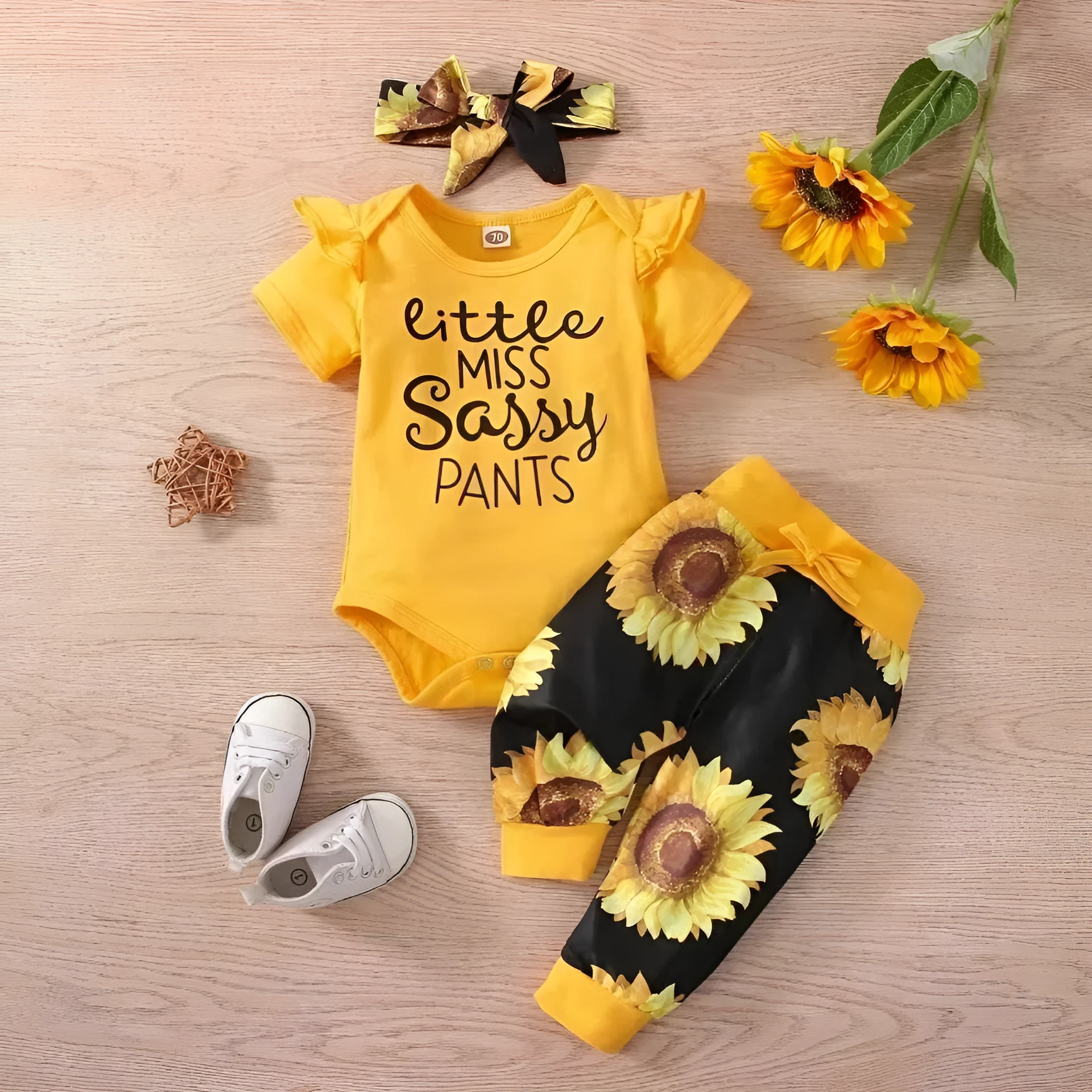 Baby jumpsuit set with cotton top, pants, and matching headband in black letter print