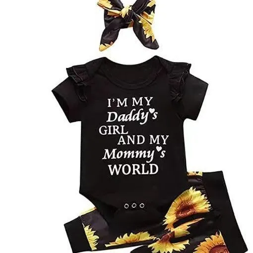 Baby jumpsuit set with cotton top, pants, and matching headband in black letter print