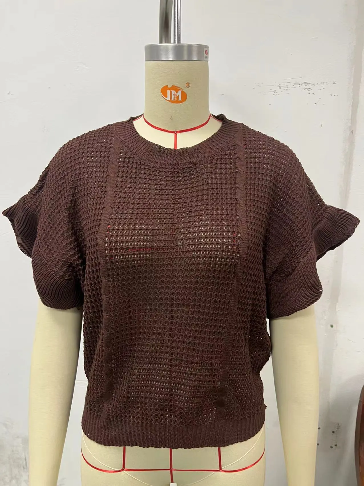 White knitted pullover sweater with twisted string ruffled short sleeves creating 3D pattern effect