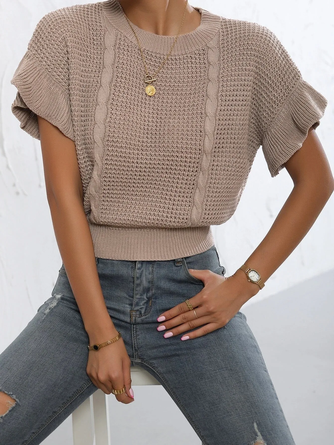 White knitted pullover sweater with twisted string ruffled short sleeves creating 3D pattern effect