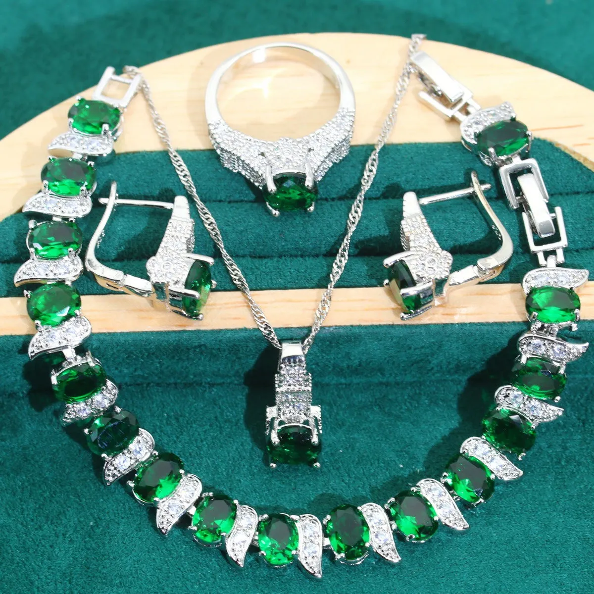 Zircon bridal jewellery four-piece set showing necklace, earrings, bracelet, and ring with alloy pendant