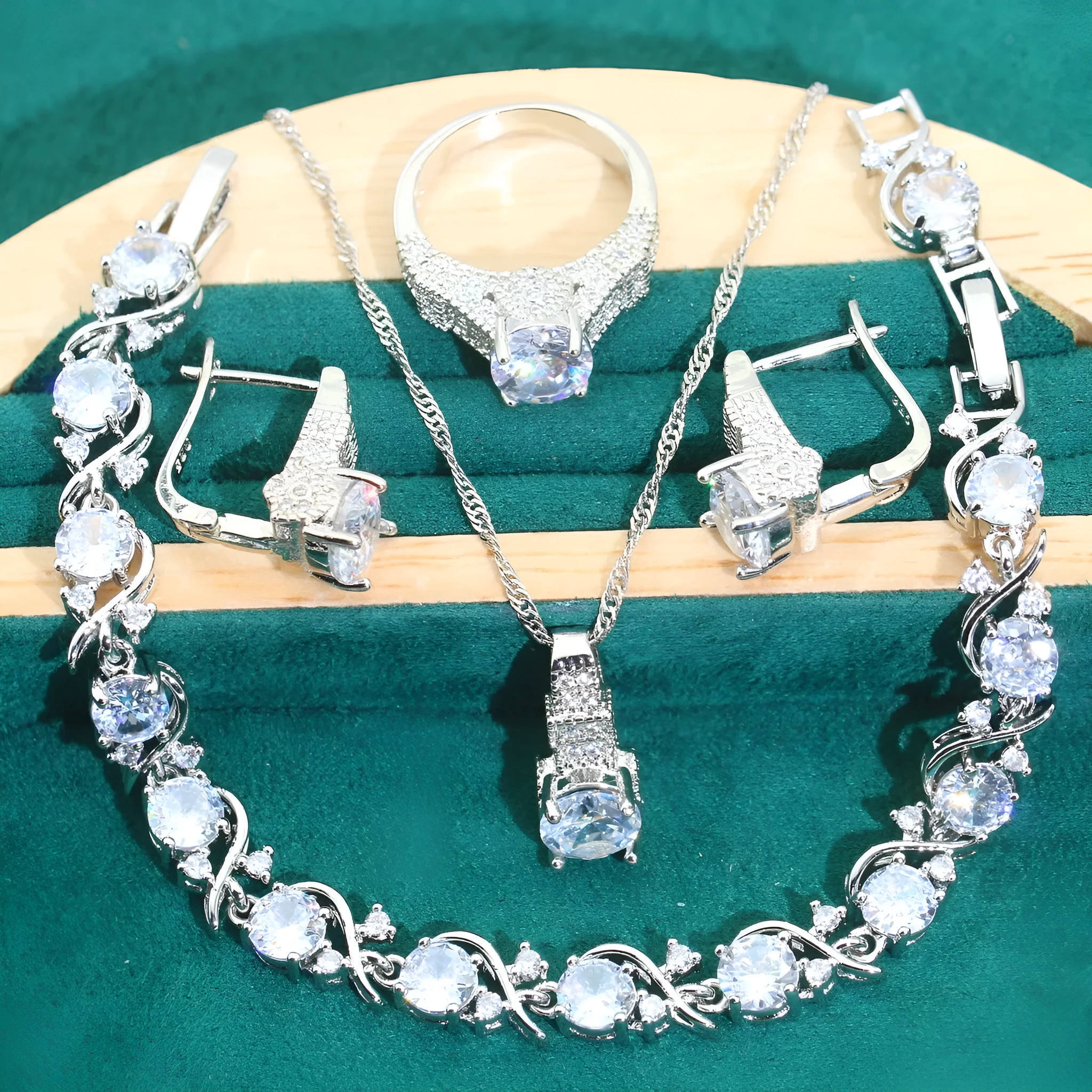 Zircon bridal jewellery four-piece set showing necklace, earrings, bracelet, and ring with alloy pendant