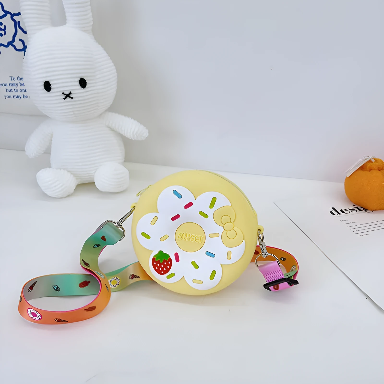 Silicone children's coin purse in round yellow with cartoon donut pattern and crossbody strap