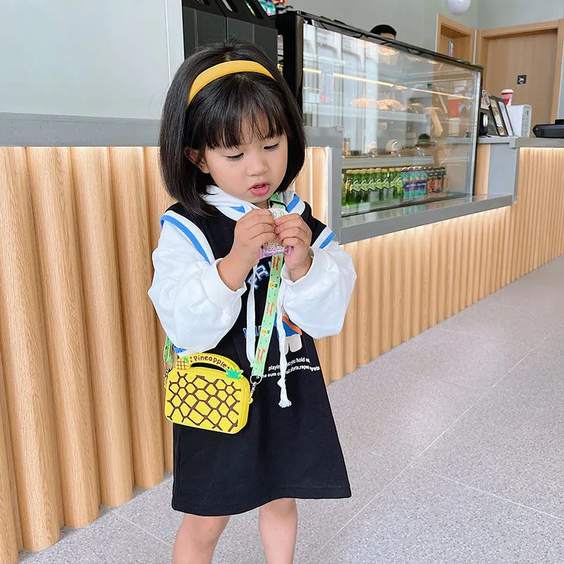 Silicone children's coin purse in round yellow with cartoon donut pattern and crossbody strap