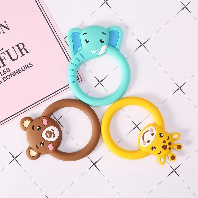 Three baby molar silicone teethers in brown, blue, and yellow on a white background