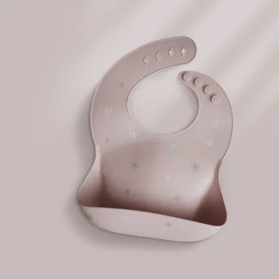 Pink baby waterproof silicone feeding bib with deep pocket and white daisy pattern