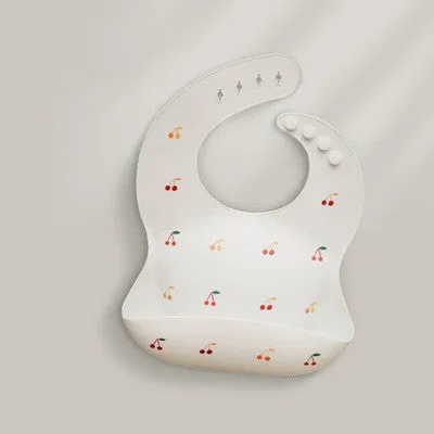 Pink baby waterproof silicone feeding bib with deep pocket and white daisy pattern