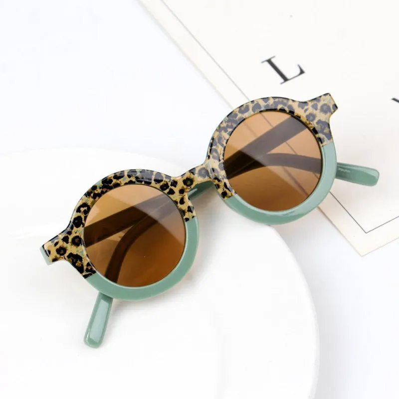 Children's round retro sunglasses with leopard print patchwork and PC frame in pink and leopard colourway