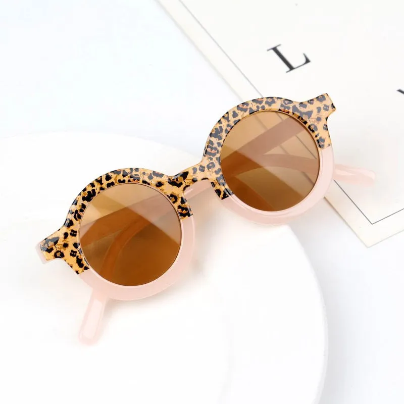 Children's round retro sunglasses with leopard print patchwork and PC frame in pink and leopard colourway