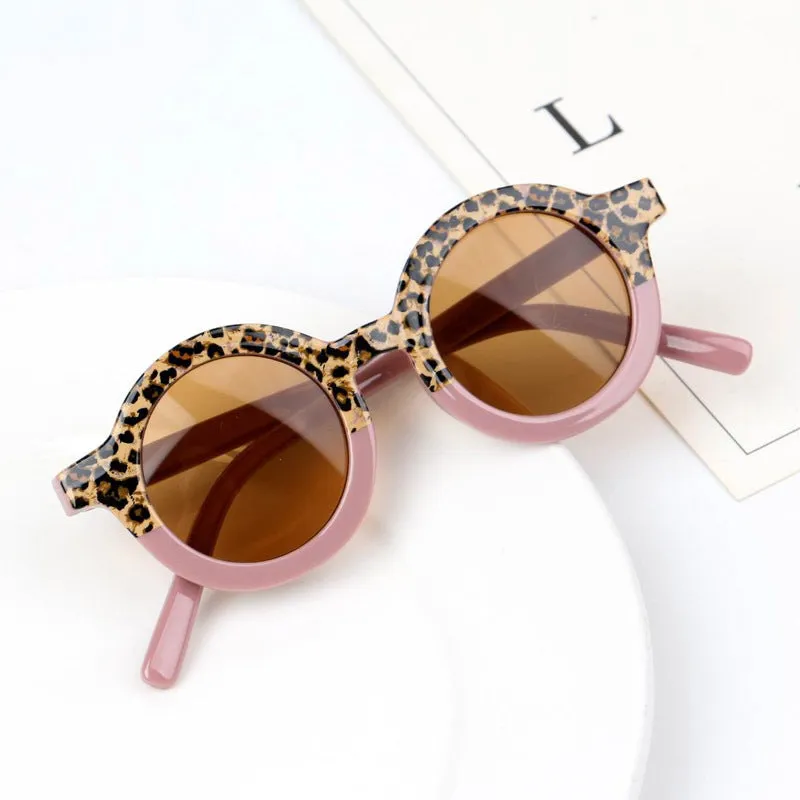 Children's round retro sunglasses with leopard print patchwork and PC frame in pink and leopard colourway