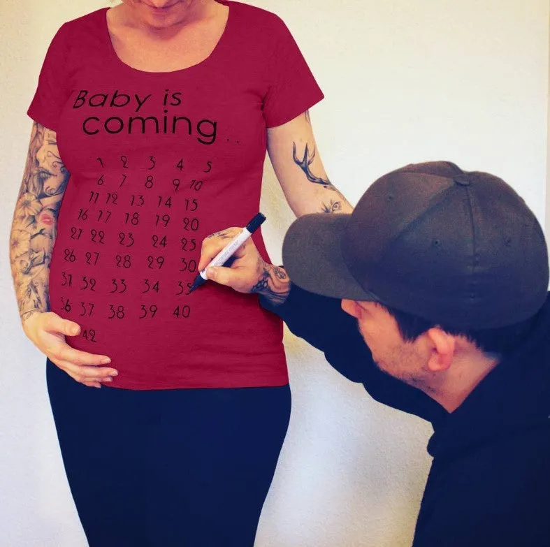 White cotton maternity t-shirt with hand print pattern, round collar, short sleeves on model