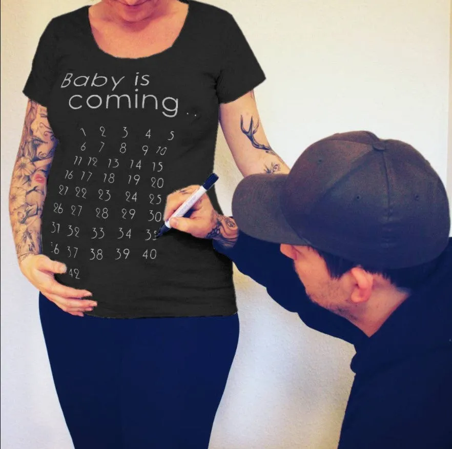 White cotton maternity t-shirt with hand print pattern, round collar, short sleeves on model
