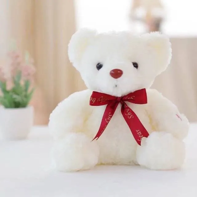Plush teddy bear with glow feature in brown colour, sitting at 25 cm height