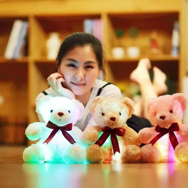 Plush teddy bear with glow feature in brown colour, sitting at 25 cm height