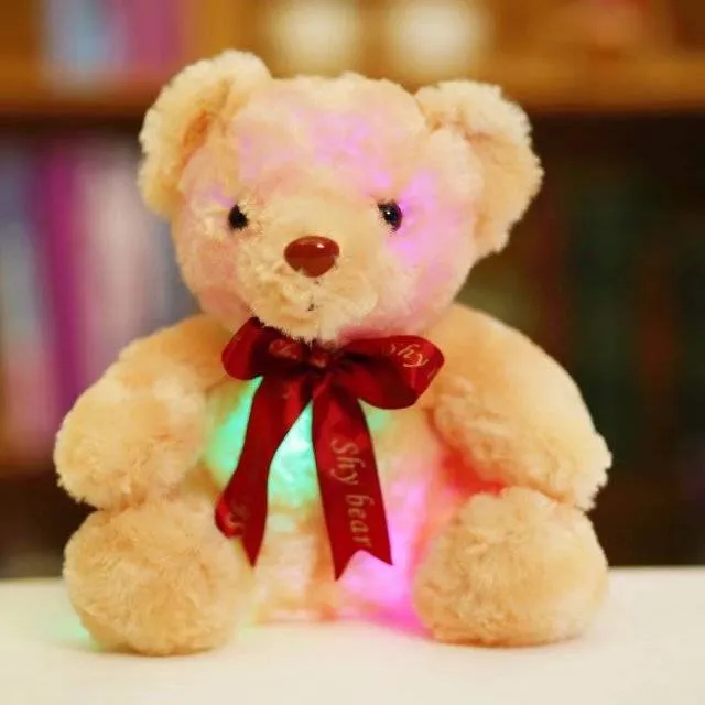 Plush teddy bear with glow feature in brown colour, sitting at 25 cm height