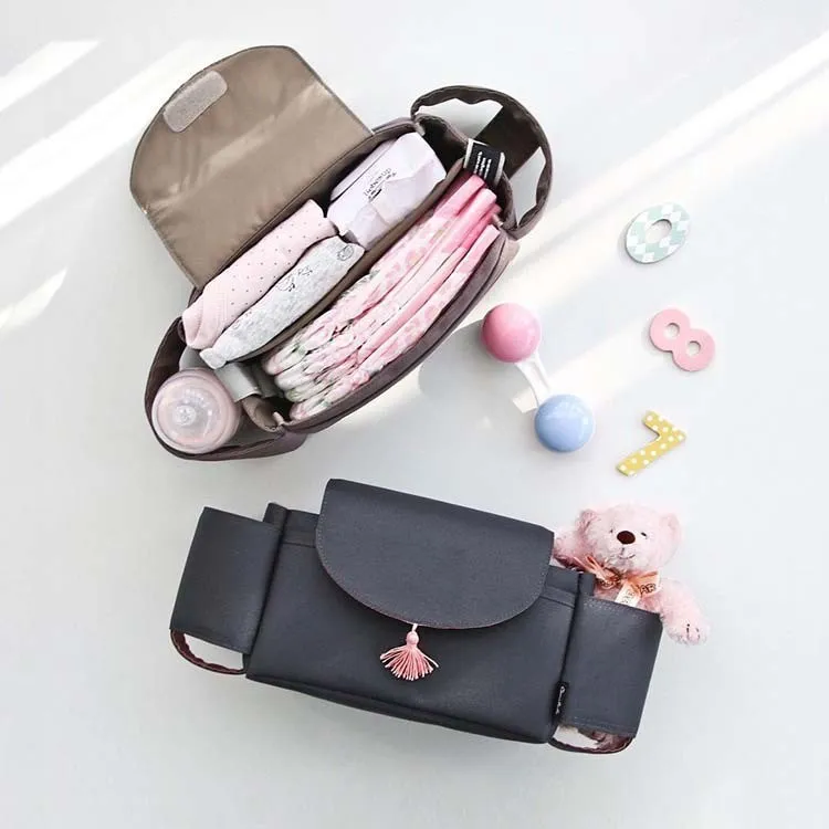 Oxford cloth hanging mommy bag with 20-35L capacity for car baby storage, in black, dark gray, sky blue, and pink tassels colours