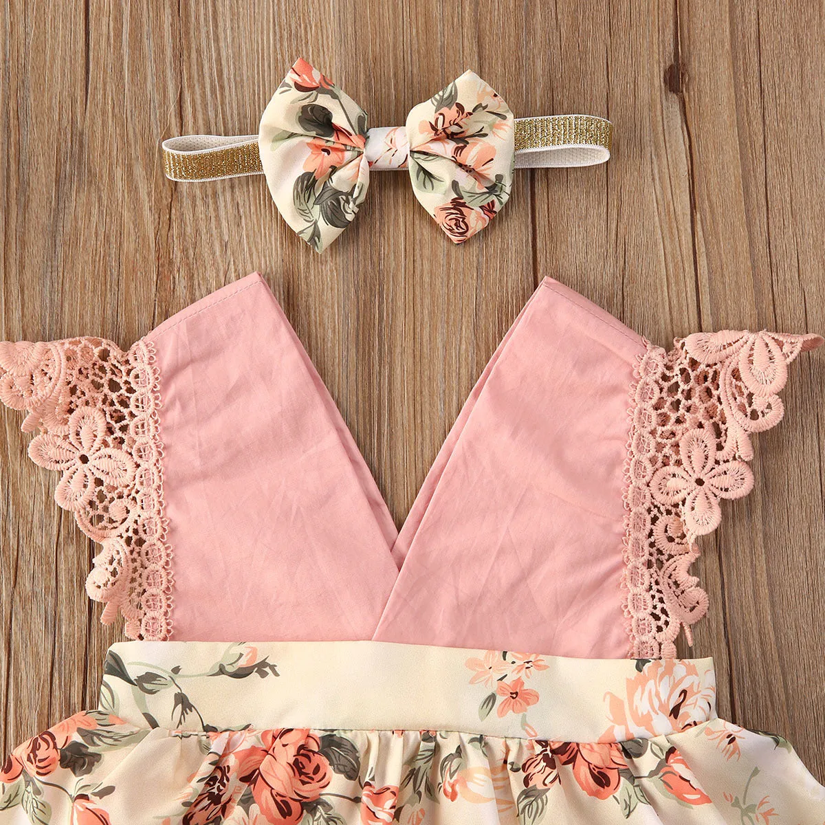 Baby girl pink floral lace V neck sleeveless jumpsuit with matching headband on white background
