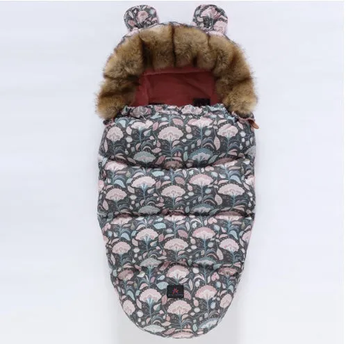Baby warm cocoon style sleeping bag on a neutral background demonstrating solid colour design with zip closure