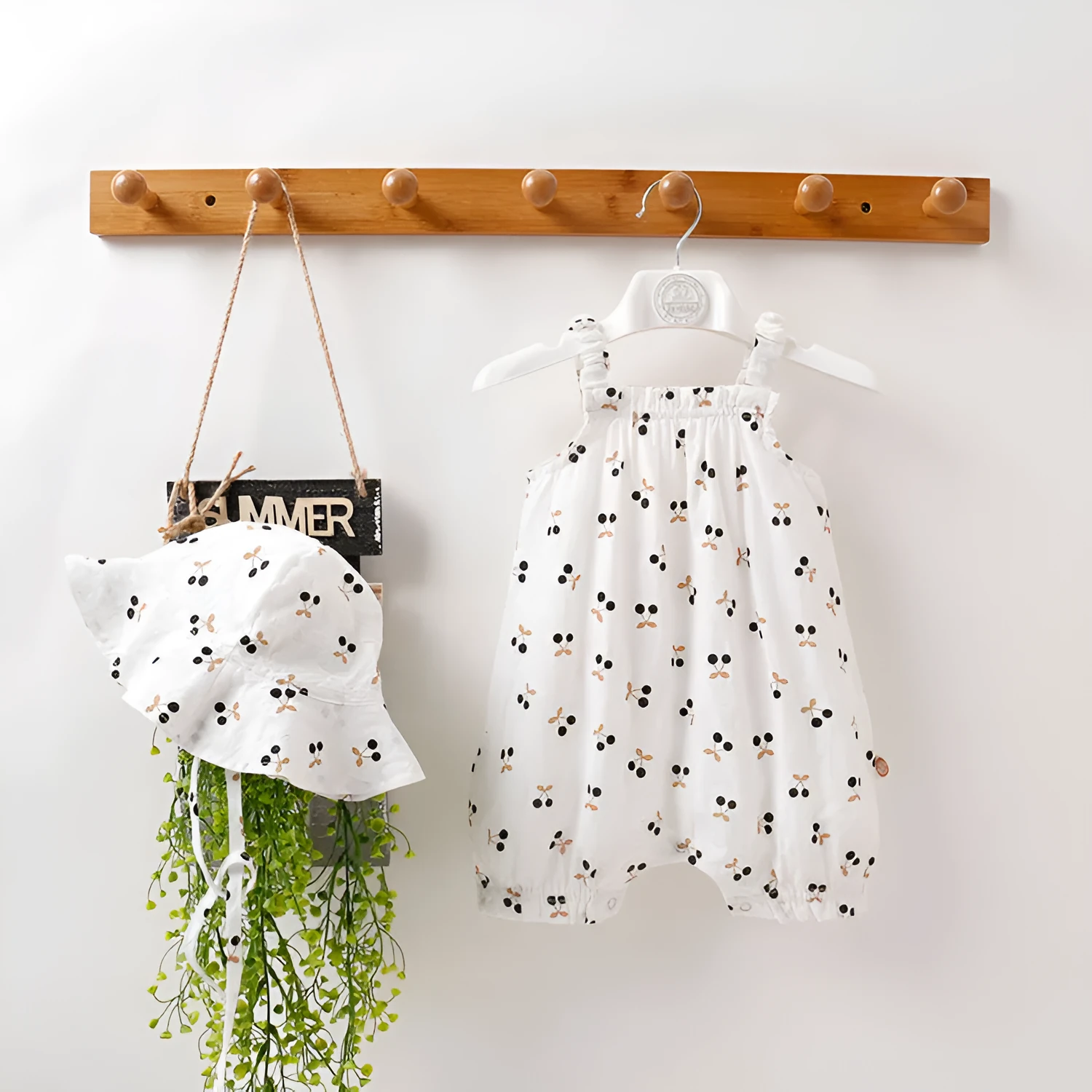 Baby girl cotton romper in smiley sunflower print sleeveless with detachable hood