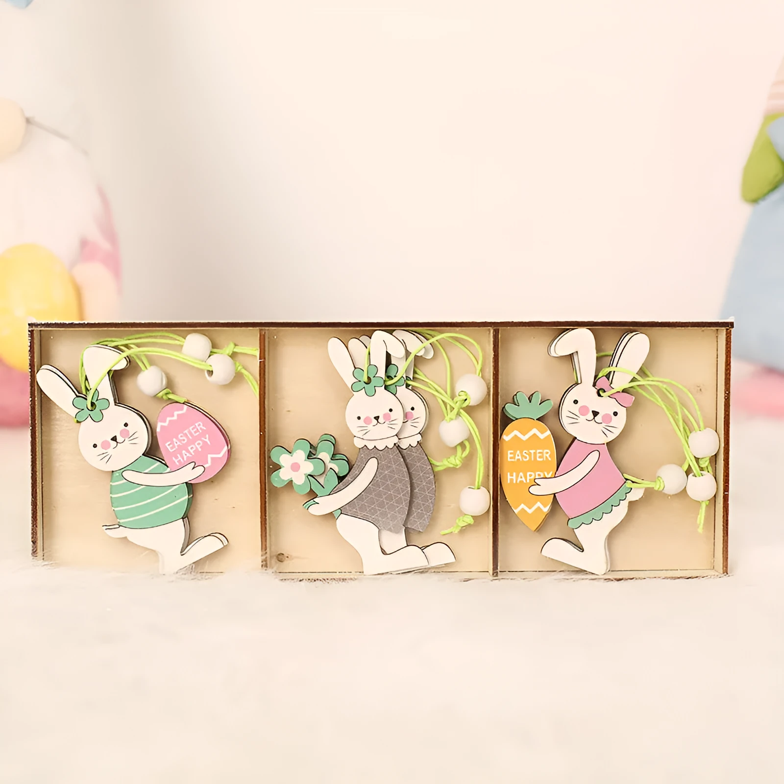 Set of 9 painted wooden Easter pendants with bunny, egg, and owl designs on a light background
