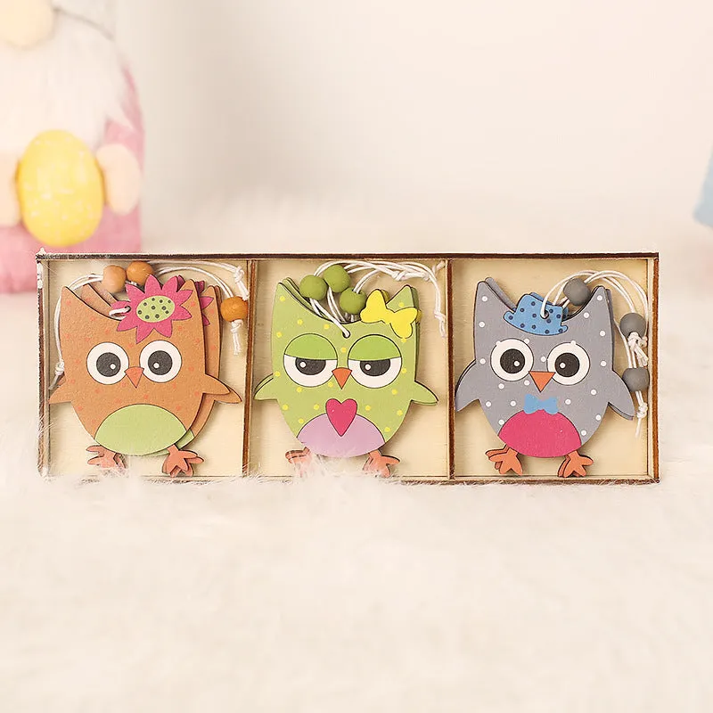 Set of 9 painted wooden Easter pendants with bunny, egg, and owl designs on a light background
