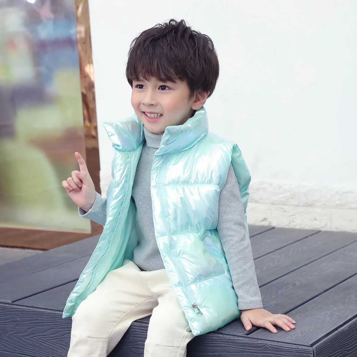 Children's down cotton vest in multicolor, with front closure, on a child, sizes 100-170cm