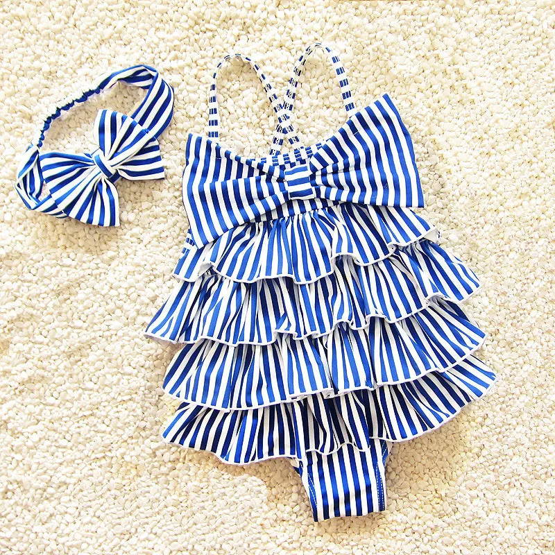 Navy style infant one-piece swimsuit with built-in steel support, pink colour with matching hair band, on a light background