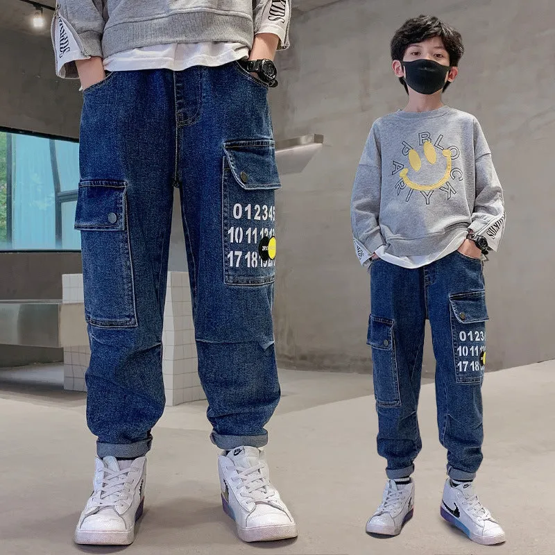 Boys printed blue cotton mid-waist girdled jeans with rubber band belt on white background