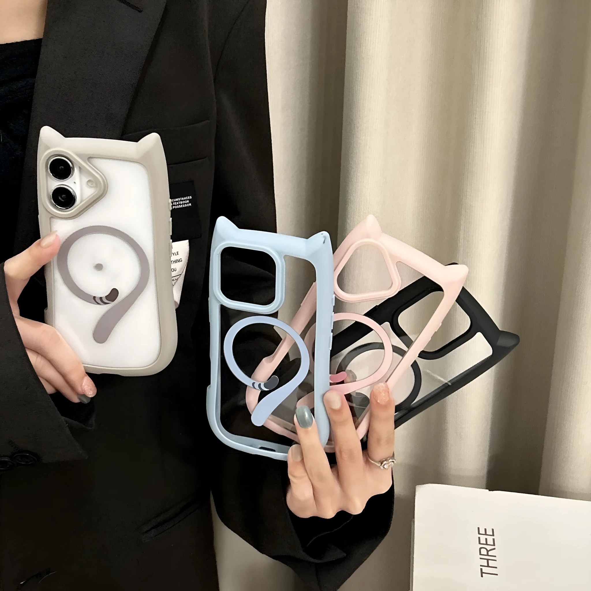Transparent acrylic TPU phone case with magnetic ring for iPhone 17 models on a table.