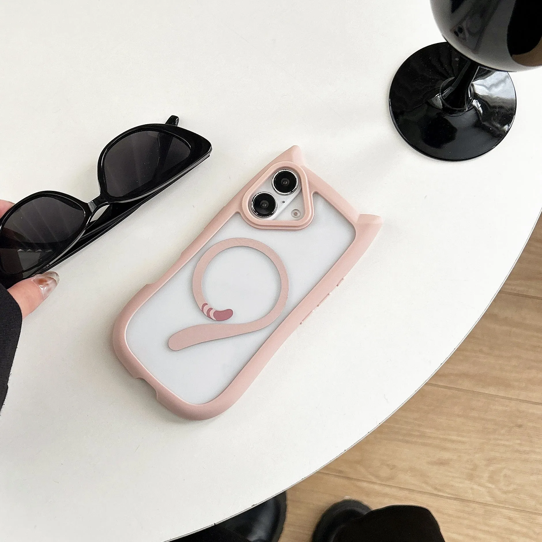 Transparent acrylic TPU phone case with magnetic ring for iPhone 17 models on a table.