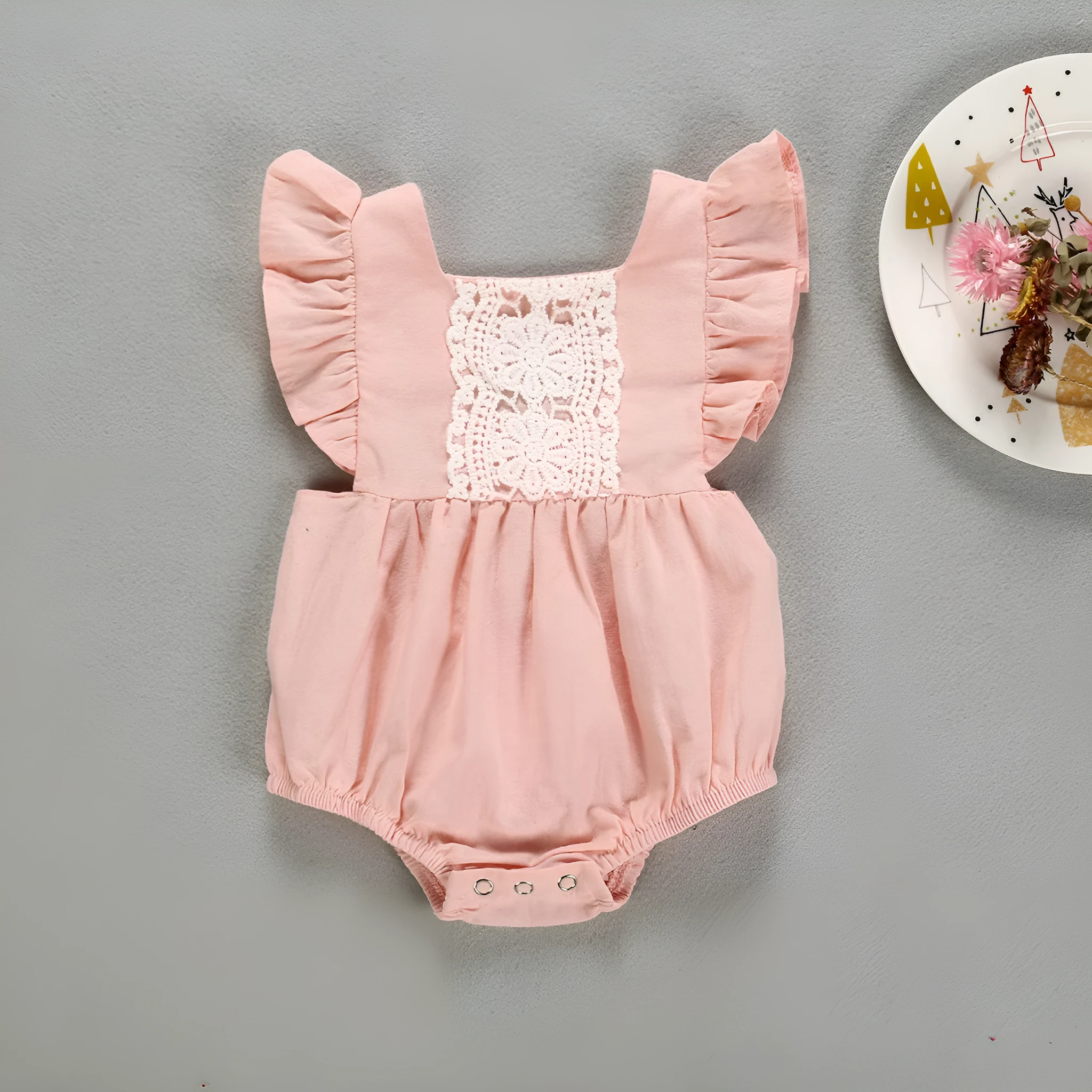 Camellia ruffles romper for baby girls with floral patchwork and back cross design in pink colour