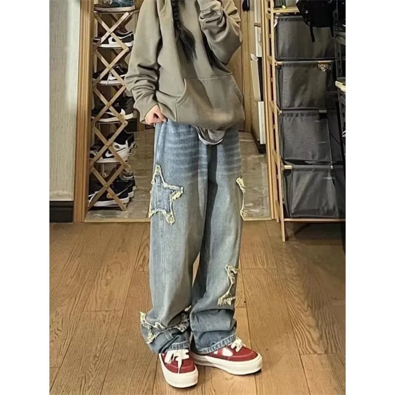 Blue high-waisted women's wide-leg denim jeans on a model, showing the straight-leg cut.