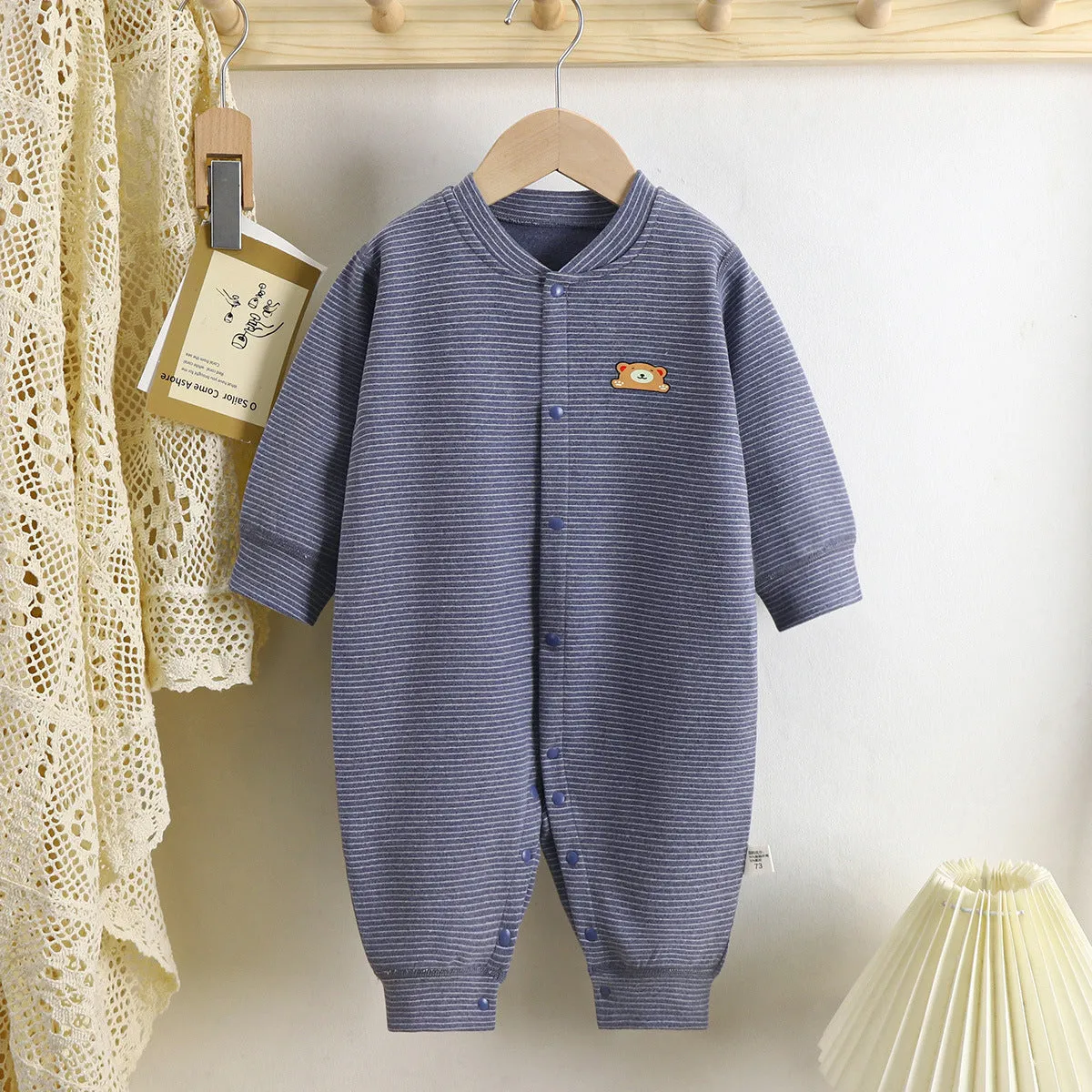 Baby Dralon striped jumpsuit romper in bean green with long sleeves and hide hook closure on white background