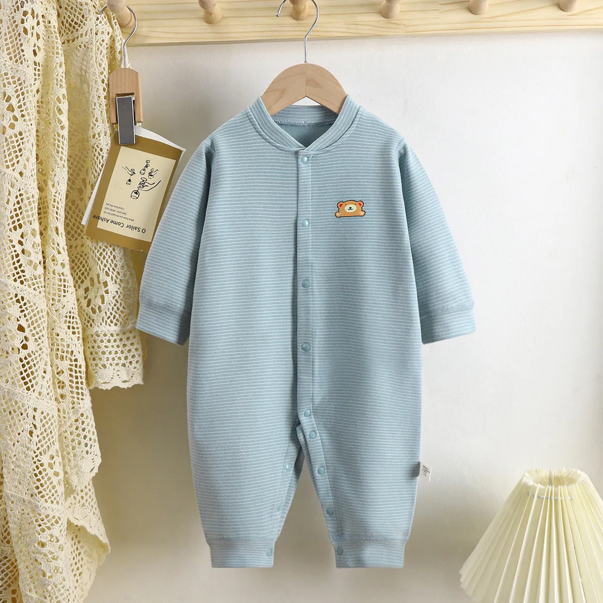 Baby Dralon striped jumpsuit romper in bean green with long sleeves and hide hook closure on white background