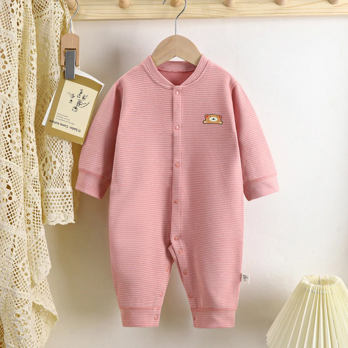 Baby Dralon striped jumpsuit romper in bean green with long sleeves and hide hook closure on white background