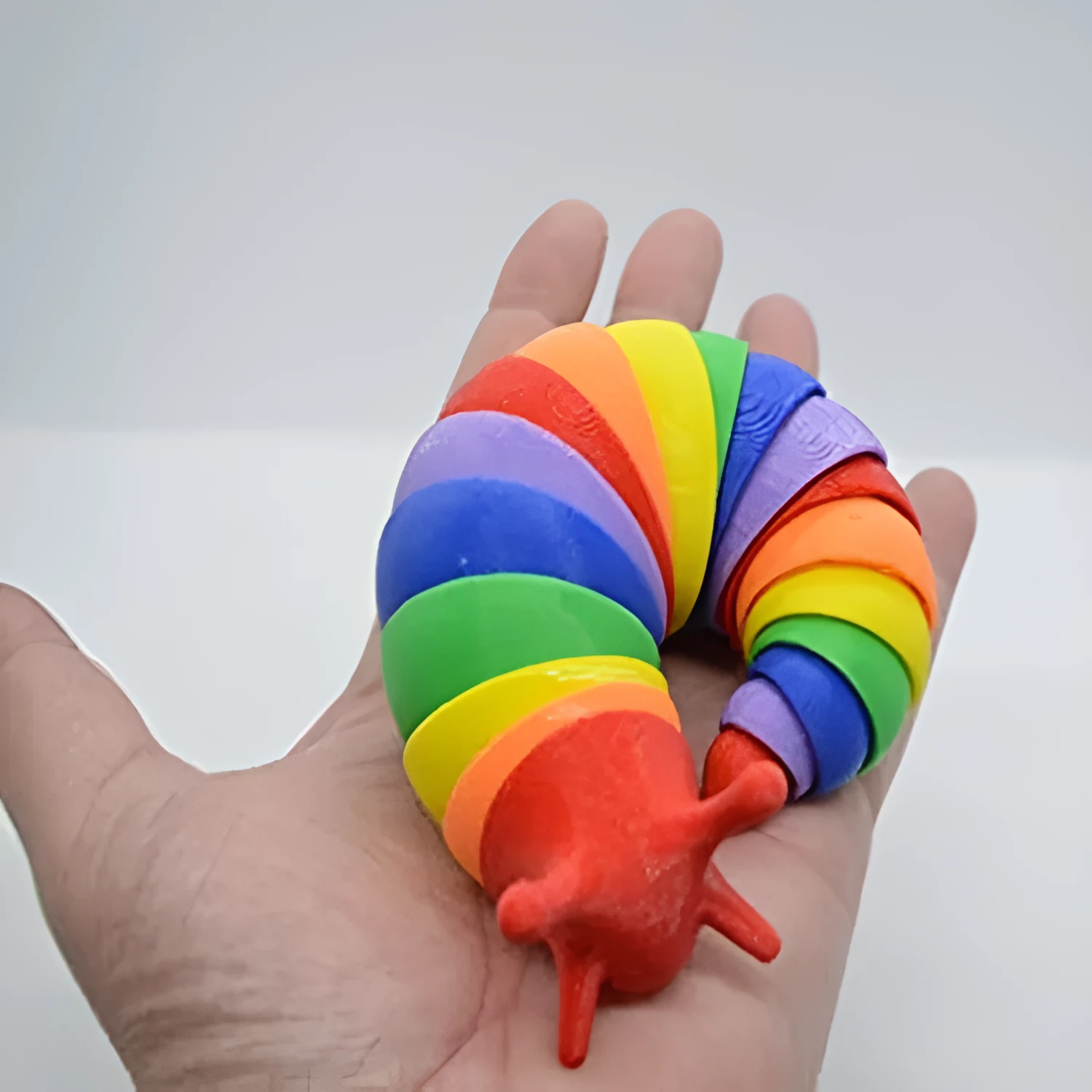 Decompression fidget toy simulation slug in blue plastic, 19 cm long, on a white background