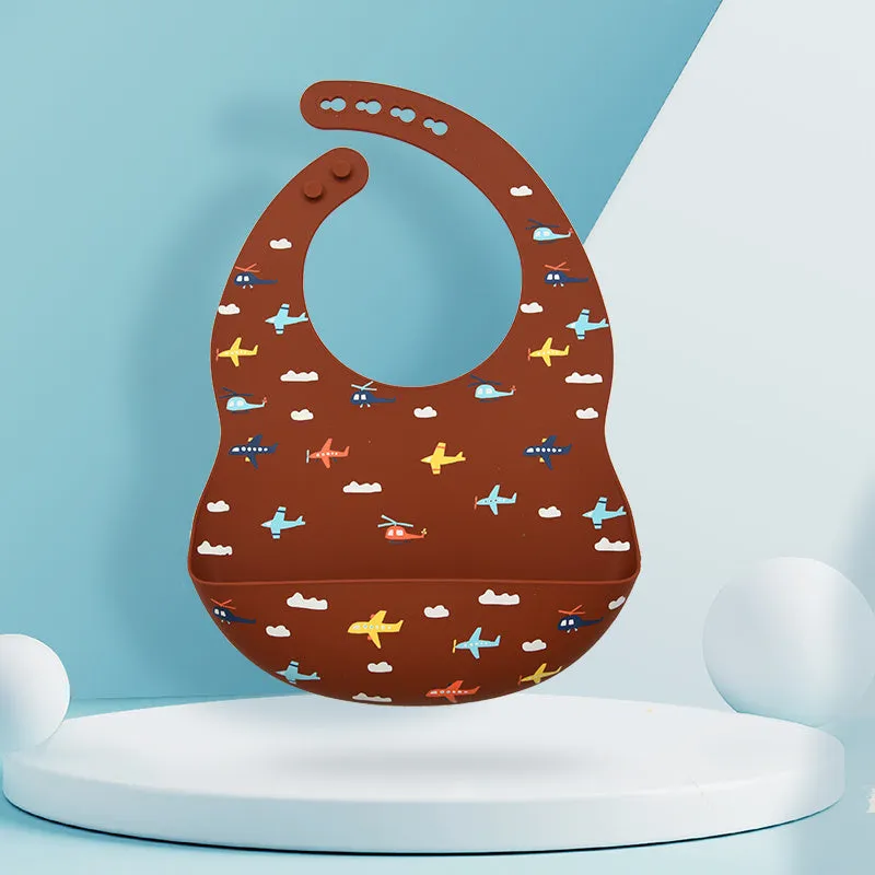 Silicone baby eating bib with adjustable neck and deep catch pocket on a child