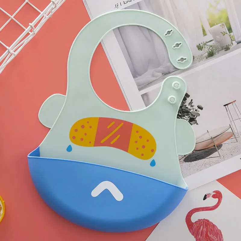 Silicone baby eating bib with adjustable neck and deep catch pocket on a child