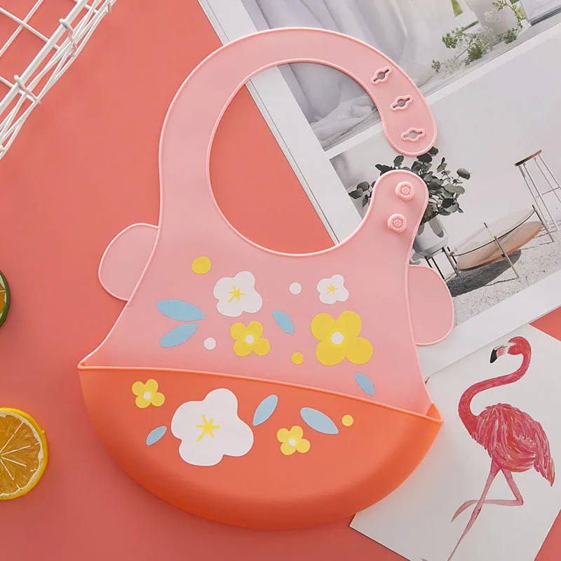 Silicone baby eating bib with adjustable neck and deep catch pocket on a child