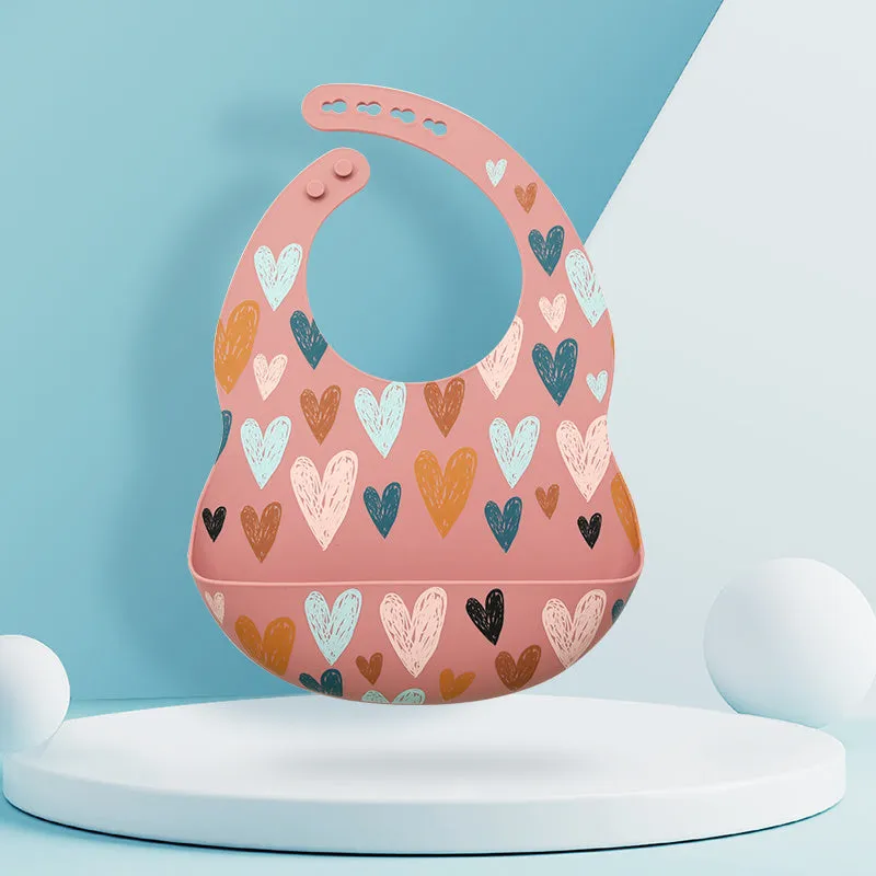 Silicone baby eating bib with adjustable neck and deep catch pocket on a child