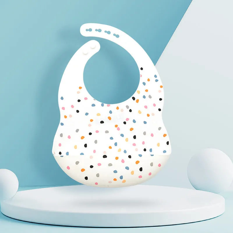 Silicone baby eating bib with adjustable neck and deep catch pocket on a child